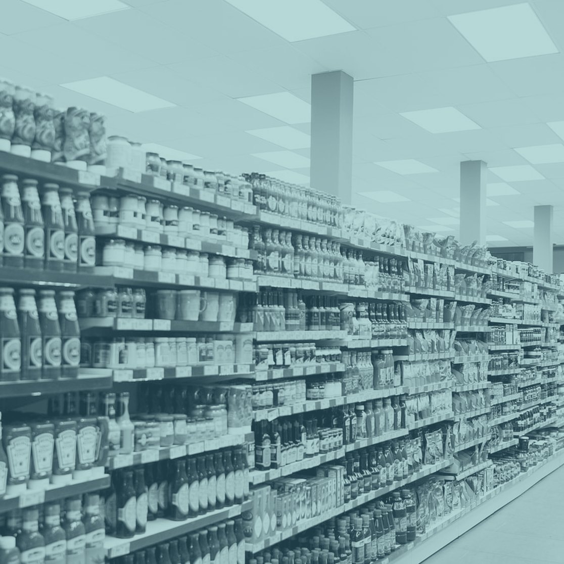 A long supermarket aisle with full shelves