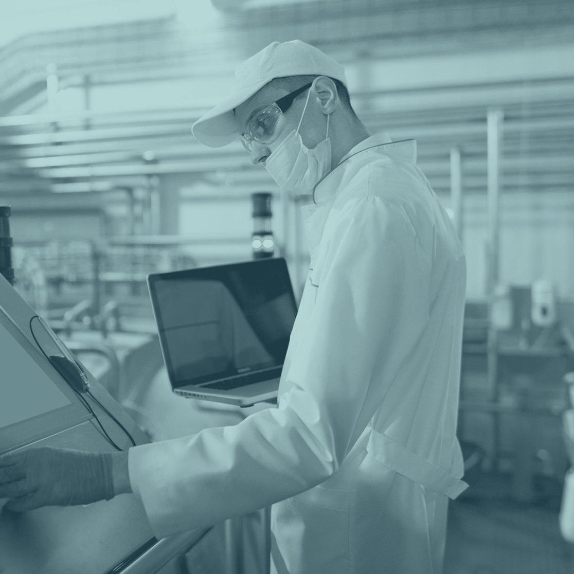 A food production specialist at a control panel